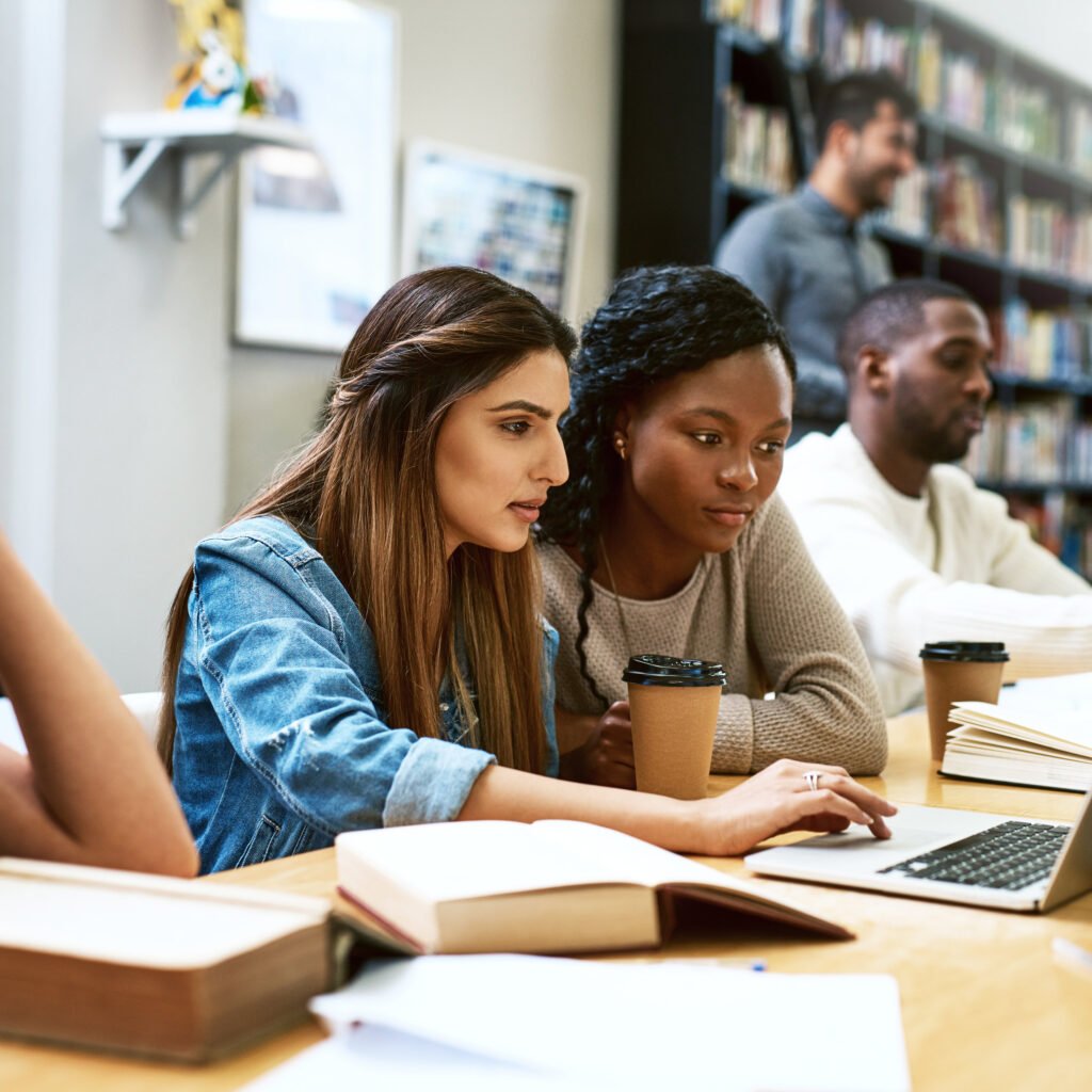 Diverse group of international students studying together in a modern university library in Germany