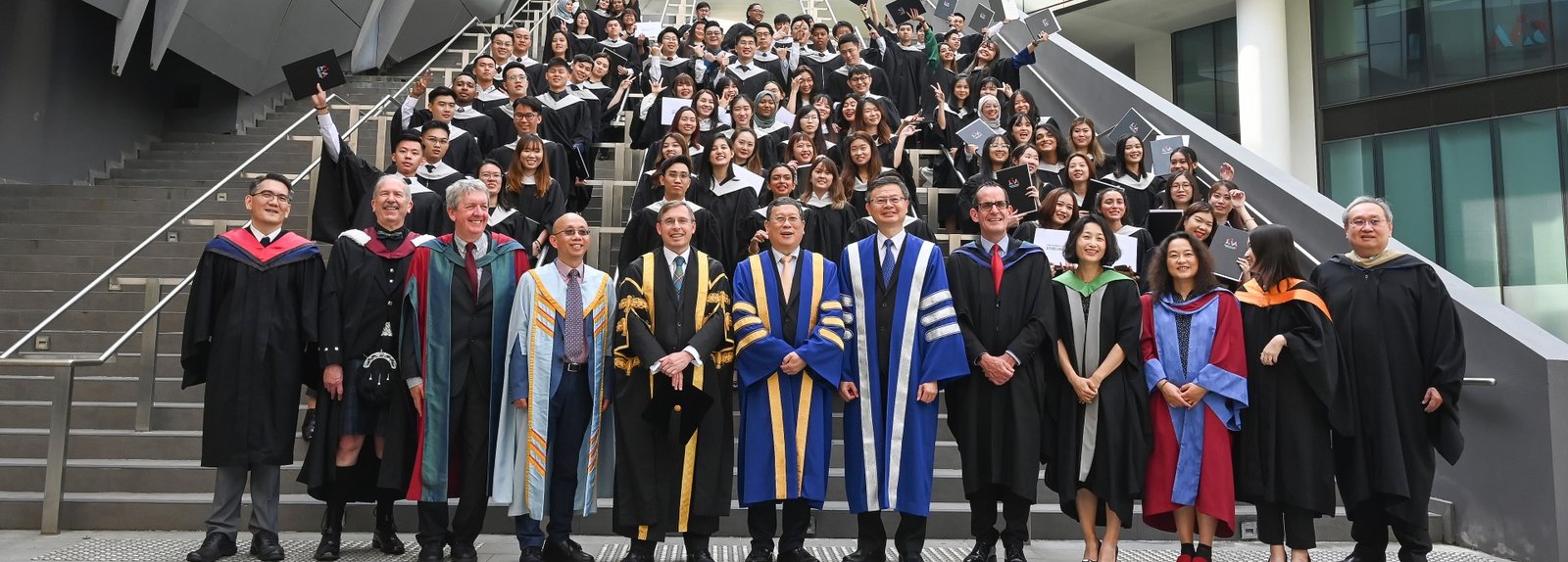 Students graduating together on a project at the University of Stirling