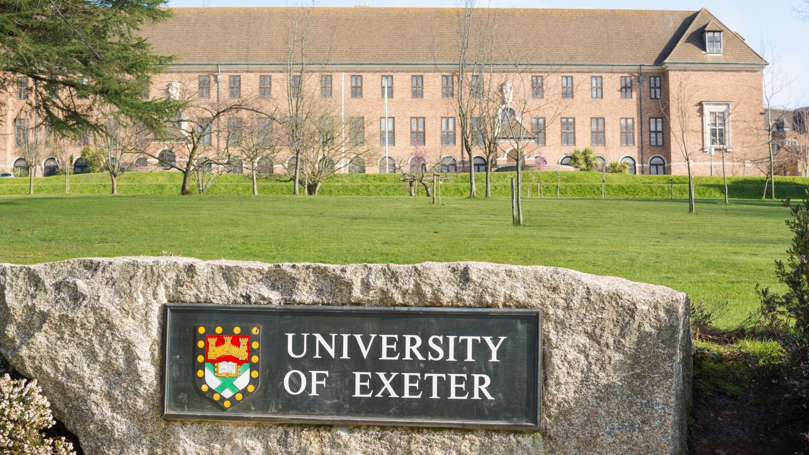 The University of Exeter’s campus surrounded by lush greenery and historic buildings.